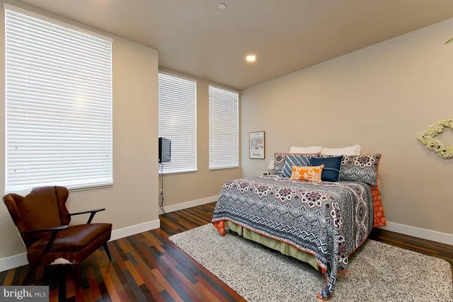 a bedroom with a bed and windows