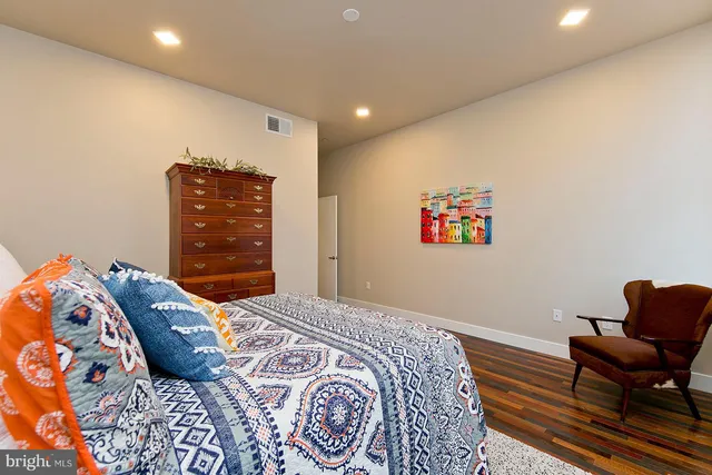 a bedroom with a bed and a chair