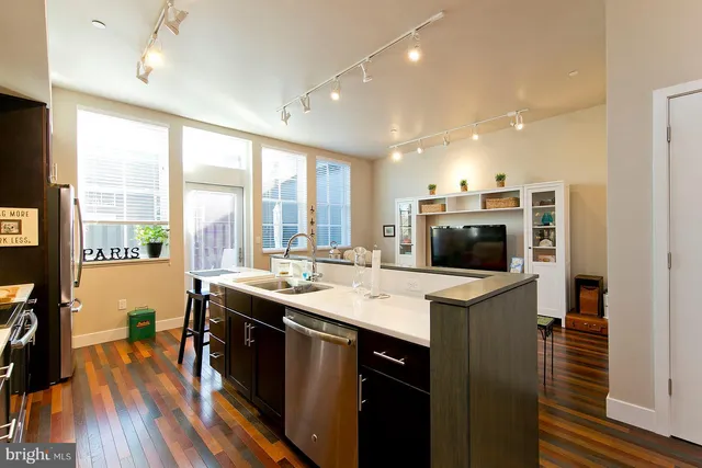 a kitchen with sink stove and refrigerator
