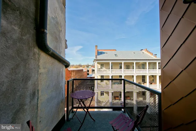 a view of a balcony with chair and wooden floor