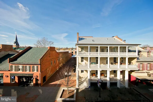 a front view of a building with a garden