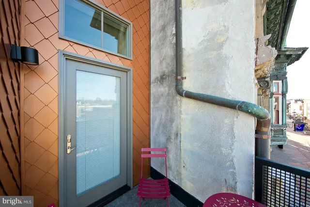 a couple of chairs sitting in a balcony