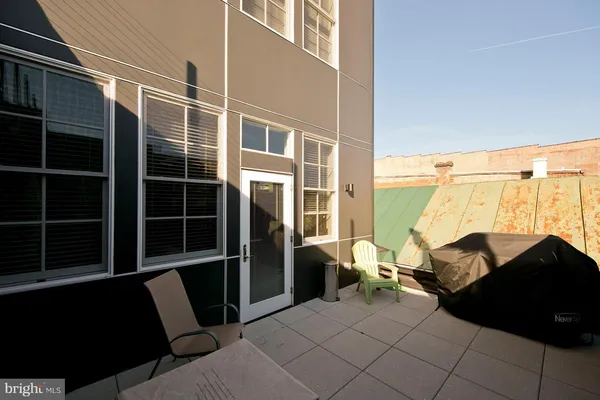a backyard of a house with table and chairs