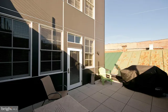 a backyard of a house with table and chairs