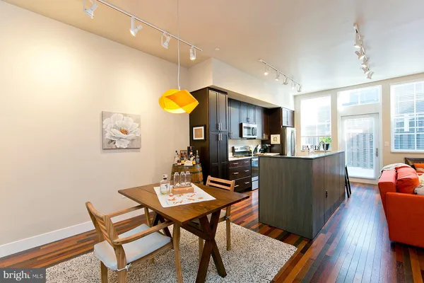 a view of a dining room with furniture and wooden floor