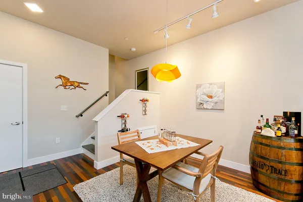 a living room with a table and a wooden floor