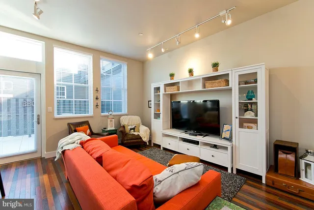 a living room with a flat screen tv and a floor to ceiling window