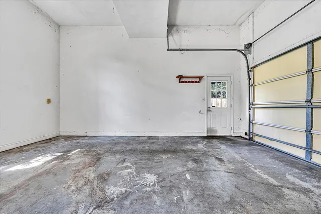 an empty room with chandelier fan