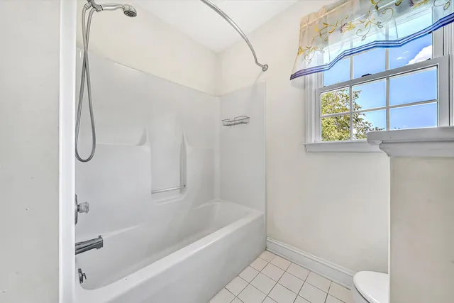 a bathroom with a toilet and shower