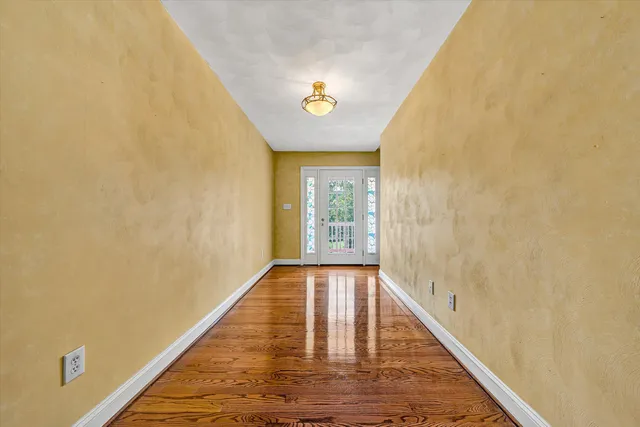 a view of a room with red door and a window