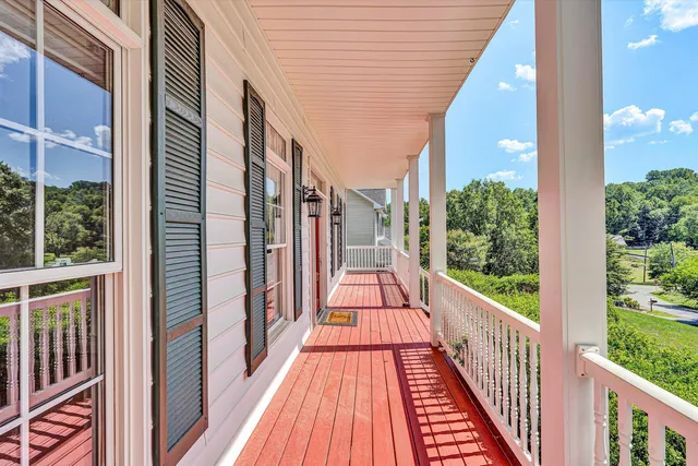 a view of a large mirror with wooden floor and door