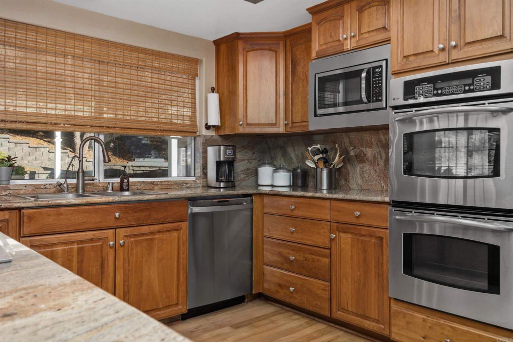 2614 Secret Lake Lane Fallbrook, CA 92028 - Photo 12 of 60 a kitchen with stainless steel appliances granite countertop a stove and cabinets