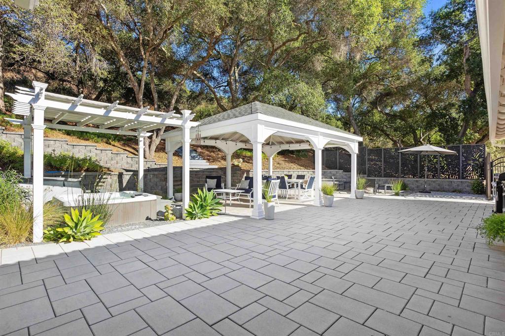 2614 Secret Lake Lane Fallbrook, CA 92028 - Photo 32 of 60 a view of a white building with a yard and sitting area