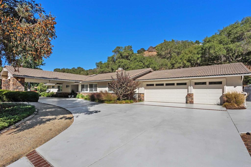 2614 Secret Lake Lane Fallbrook, CA 92028 - Photo 50 of 60 a front view of a house with a yard and garage