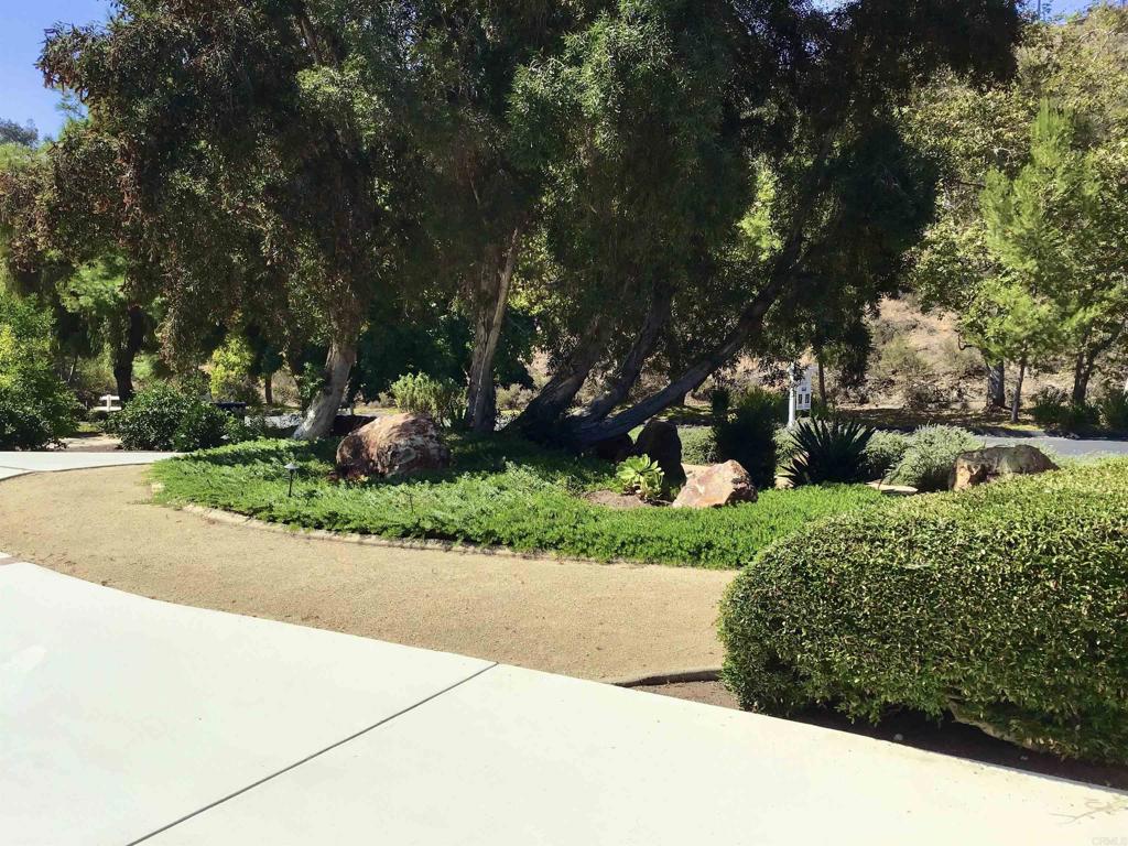 2614 Secret Lake Lane Fallbrook, CA 92028 - Photo 52 of 60 a view of a garden with a bench
