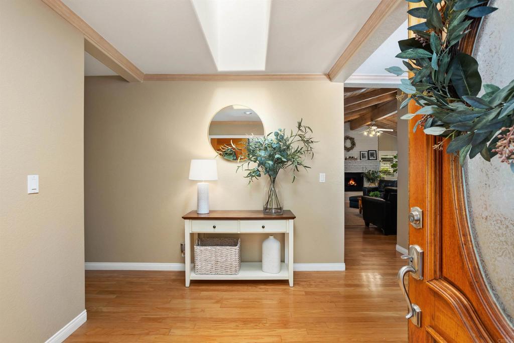 2614 Secret Lake Lane Fallbrook, CA 92028 - Photo 6 of 60 a view of a hallway with wooden floor and a potted plant