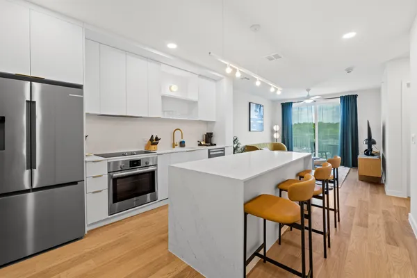 a kitchen with a sink a counter top space and cabinets