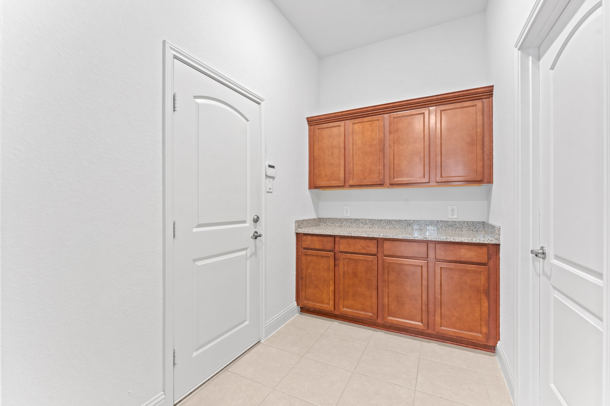 39 Tioga Place Tomball, TX 77375 - Photo 11 of 50 a kitchen with granite countertop white cabinets and white appliances