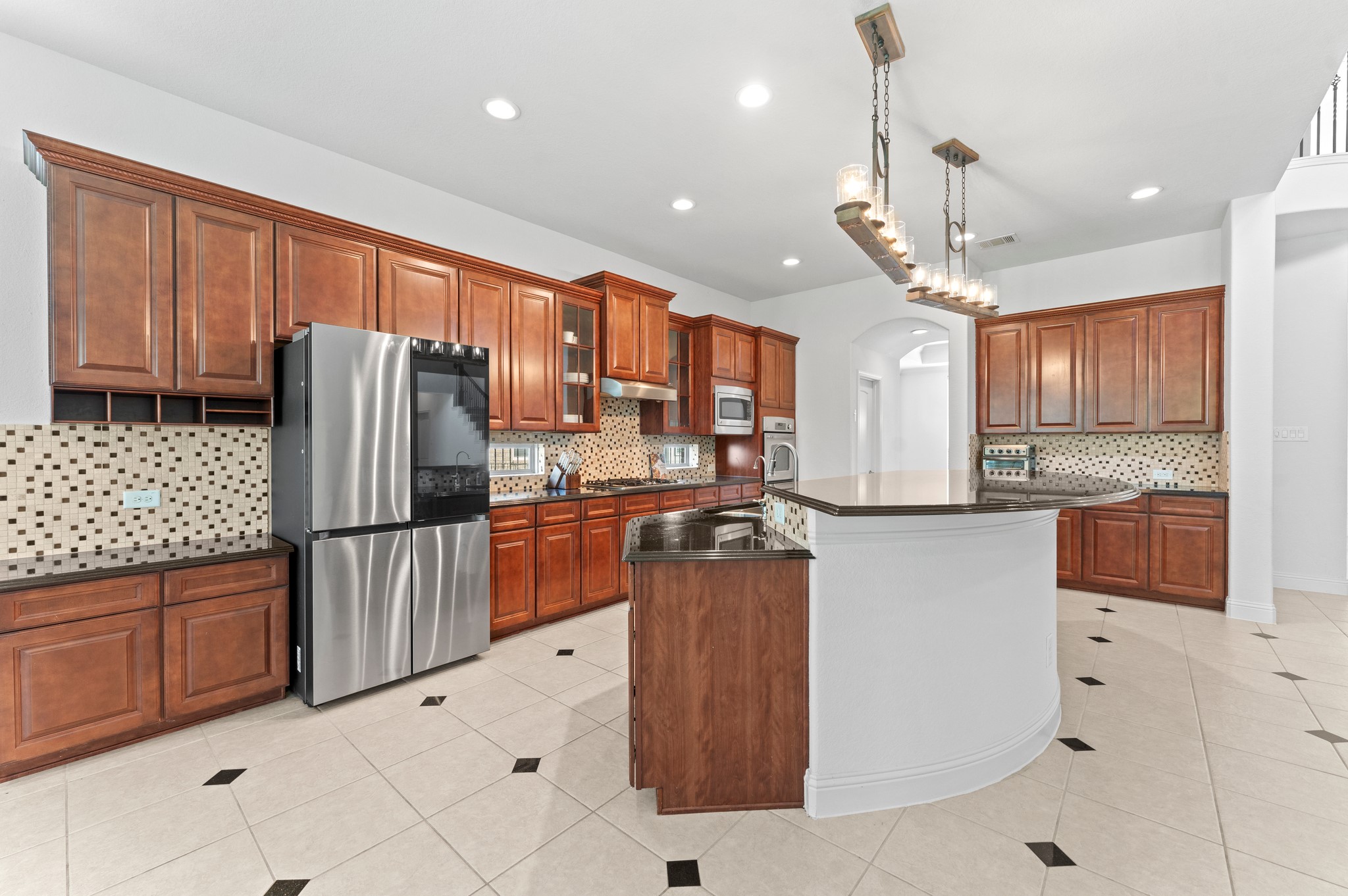 39 Tioga Place Tomball, TX 77375 - Photo 20 of 50 a kitchen with stainless steel appliances granite countertop a refrigerator and a sink