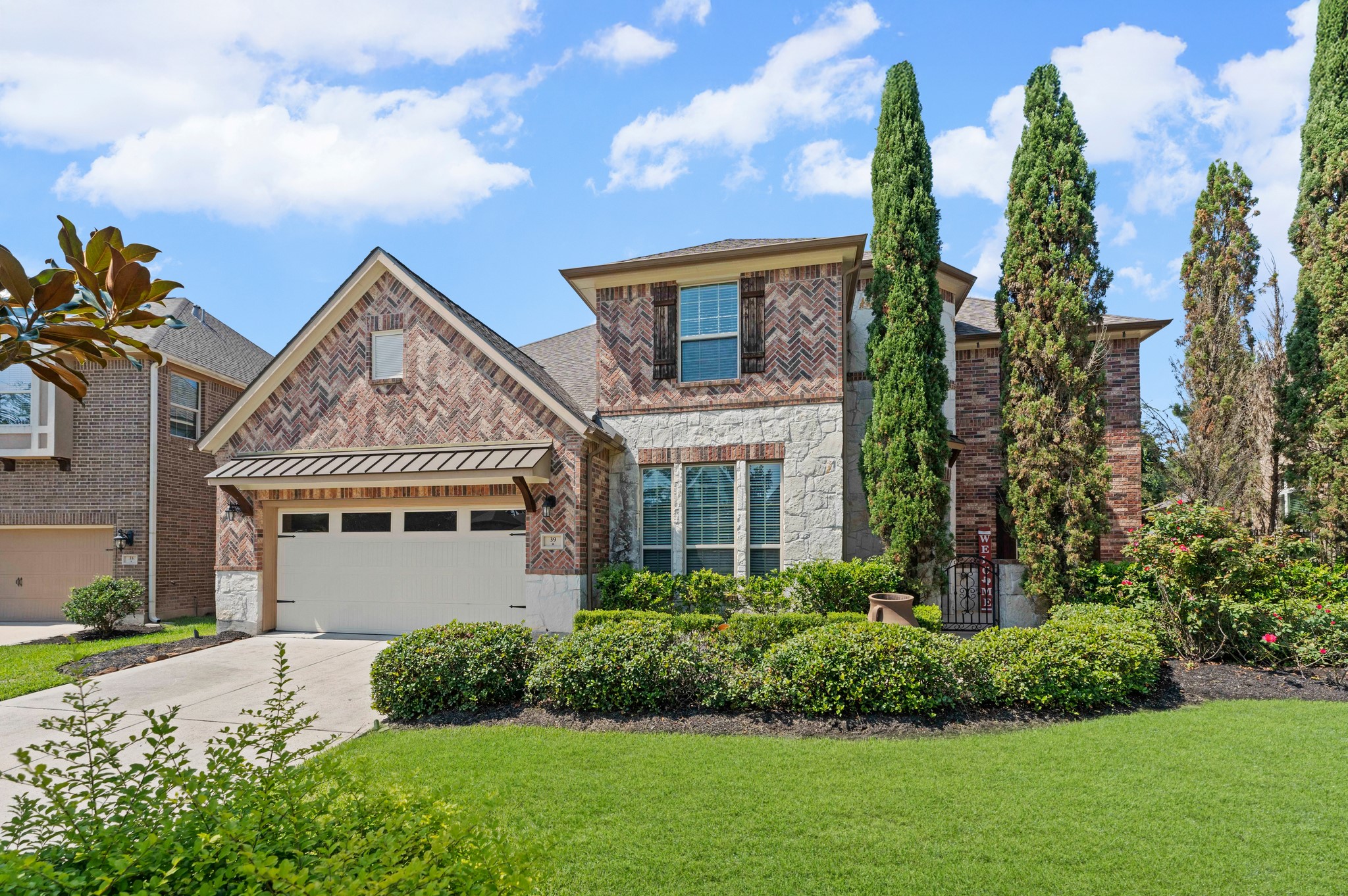 39 Tioga Place Tomball, TX 77375 - Photo 2 of 50 a front view of a house with a yard