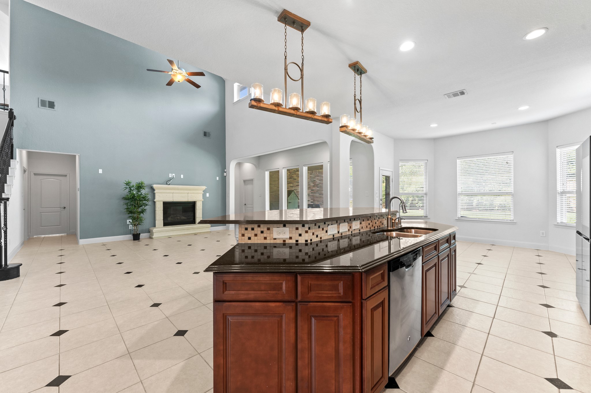 39 Tioga Place Tomball, TX 77375 - Photo 22 of 50 a kitchen with stainless steel appliances kitchen island granite countertop a stove a sink and a refrigerator