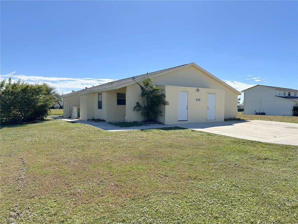 320 Boundary Boulevard, Unit A Rotonda West, FL 33947 - Photo 2 of 11 a view of a house with backyard