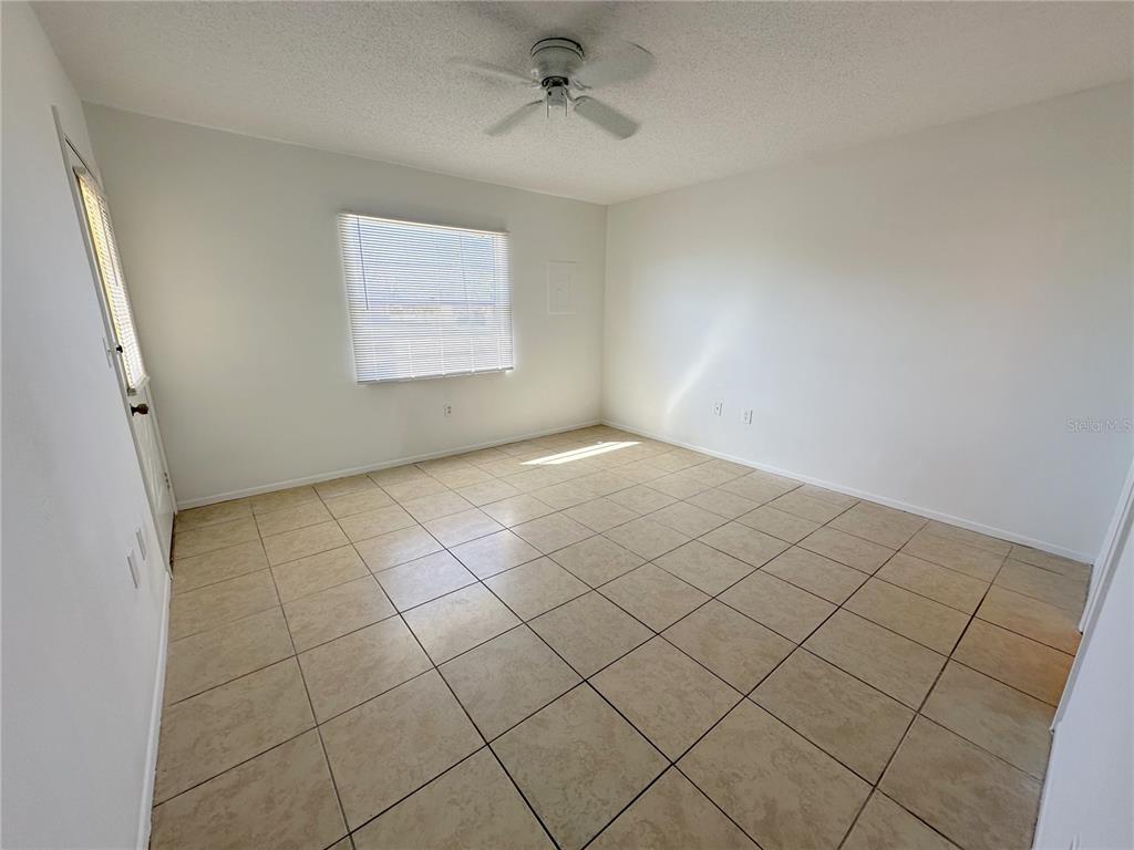 320 Boundary Boulevard, Unit A Rotonda West, FL 33947 - Photo 6 of 11 an empty room with windows