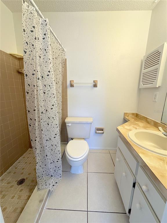 320 Boundary Boulevard, Unit A Rotonda West, FL 33947 - Photo 7 of 11 a bathroom with a granite countertop toilet and a sink