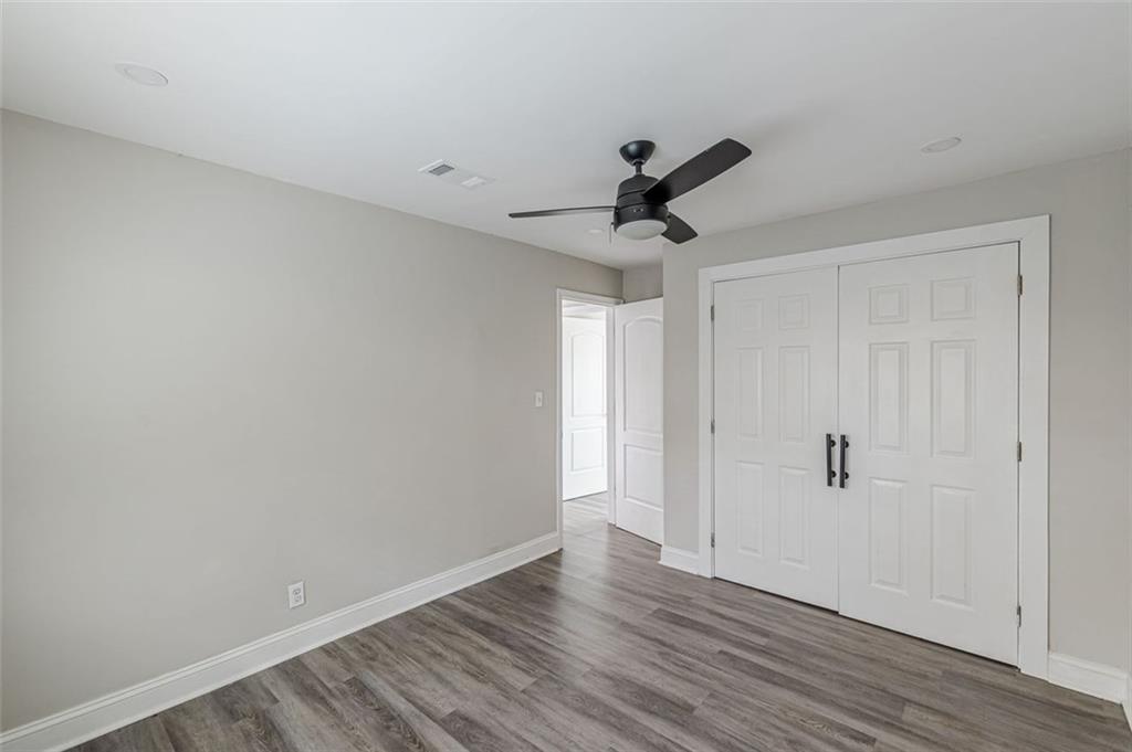 919 Hobson Street Southwest Atlanta, GA 30310 - Photo 12 of 24 a view of a room with wooden floor and ceiling fan