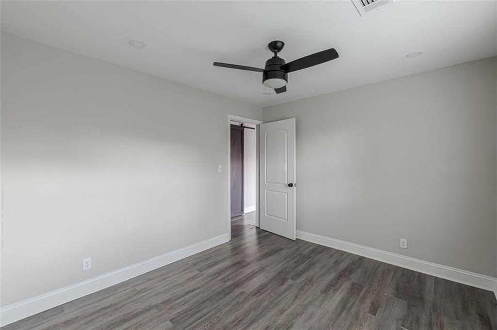 919 Hobson Street Southwest Atlanta, GA 30310 - Photo 15 of 24 a view of a room with wooden floor and ceiling fan