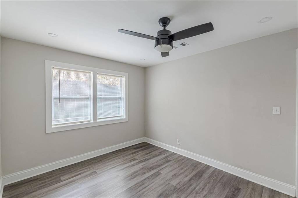 919 Hobson Street Southwest Atlanta, GA 30310 - Photo 16 of 24 an empty room with a window and a ceiling fan