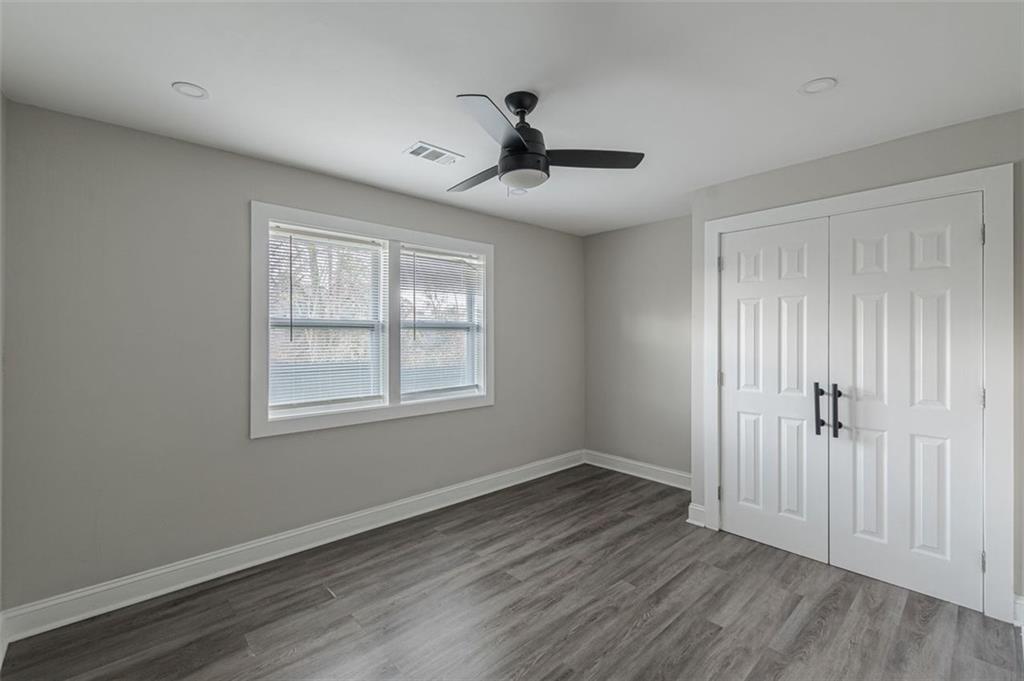 919 Hobson Street Southwest Atlanta, GA 30310 - Photo 17 of 24 a view of empty room with wooden floor and fan