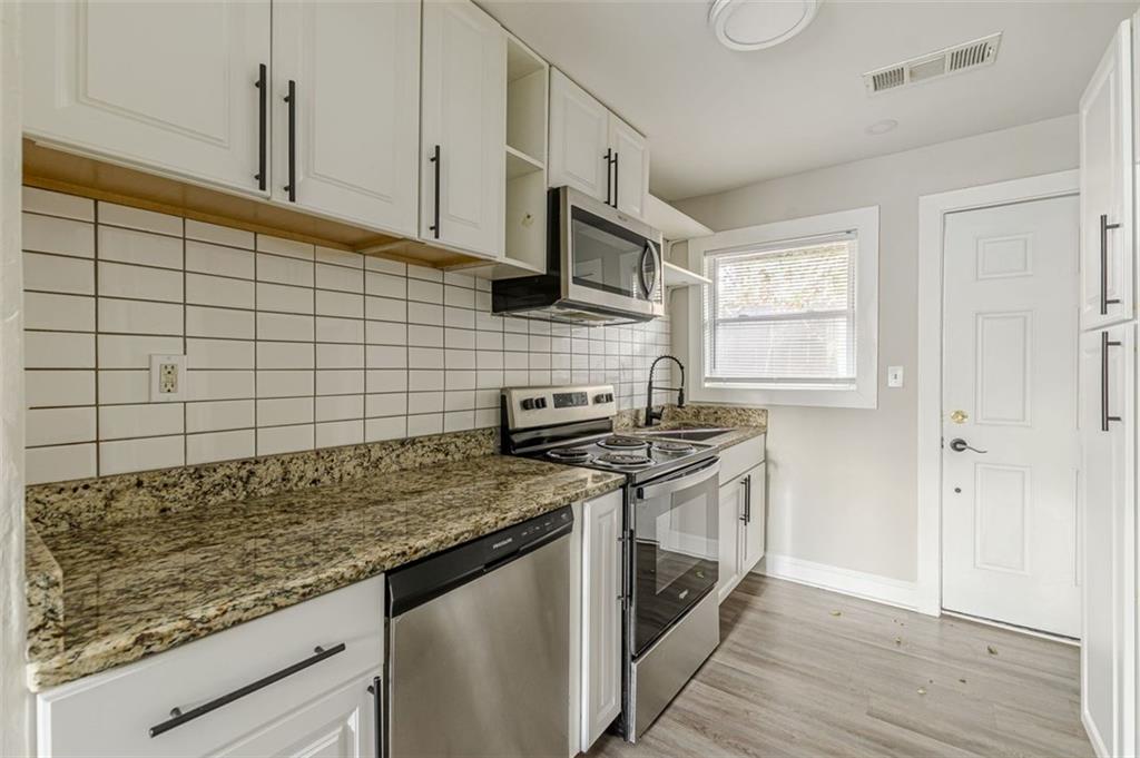 919 Hobson Street Southwest Atlanta, GA 30310 - Photo 18 of 24 a kitchen with stainless steel appliances granite countertop a stove and a sink