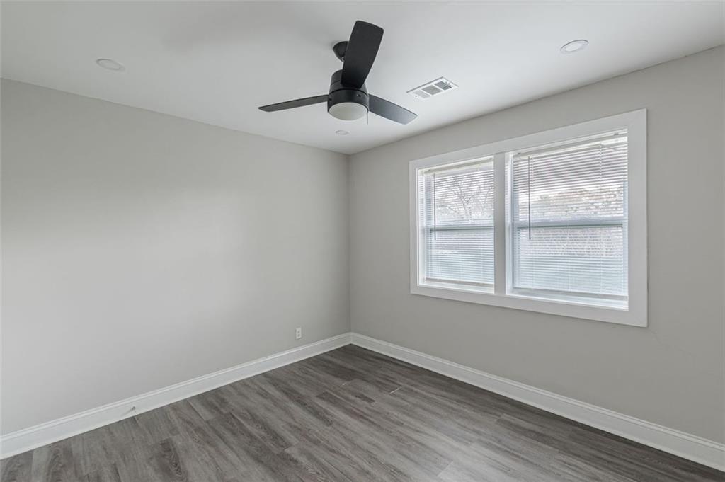 919 Hobson Street Southwest Atlanta, GA 30310 - Photo 19 of 24 wooden floor in an empty room with a window