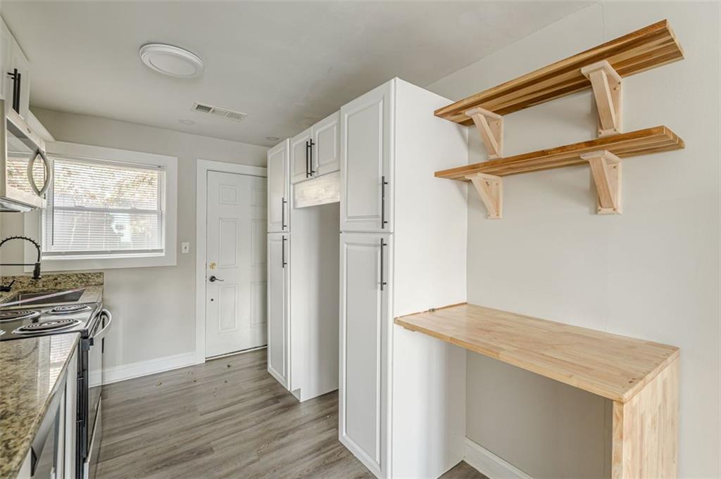 919 Hobson Street Southwest Atlanta, GA 30310 - Photo 5 of 24 a view of walk in closet with window and wooden floor