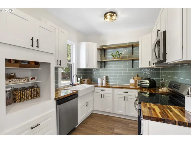 a kitchen with a sink a stove and cabinets