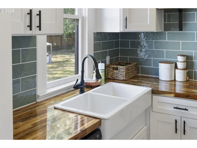 a kitchen with a sink a stove and cabinets