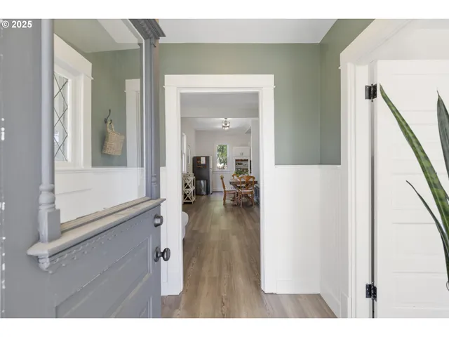 a hallway with wooden floor and furniture