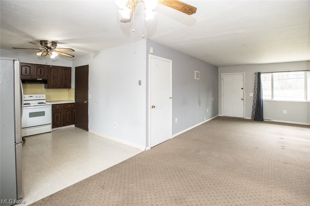 14358 Prospect Road Strongsville, OH 44149 - Photo 10 of 35 Kitchen with electric stove, dark brown cabinetry, ceiling fan, stainless steel refrigerator, and light tile floors