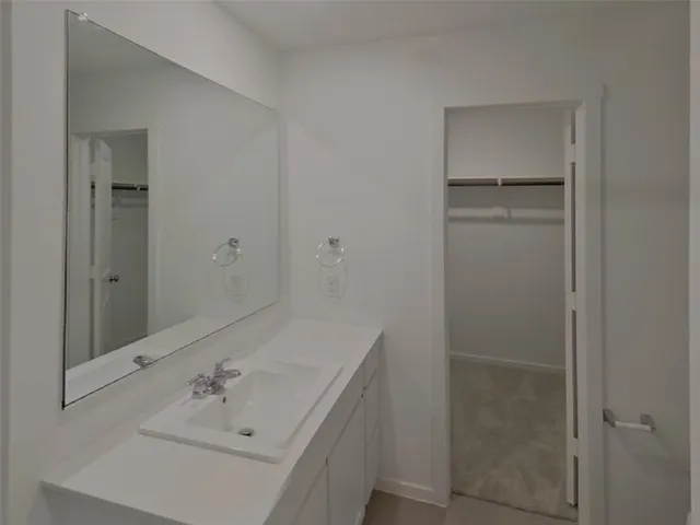 a bathroom with a sink and mirror