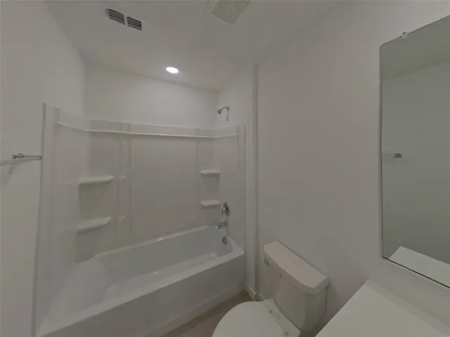 a bathroom with a bathtub and toilet