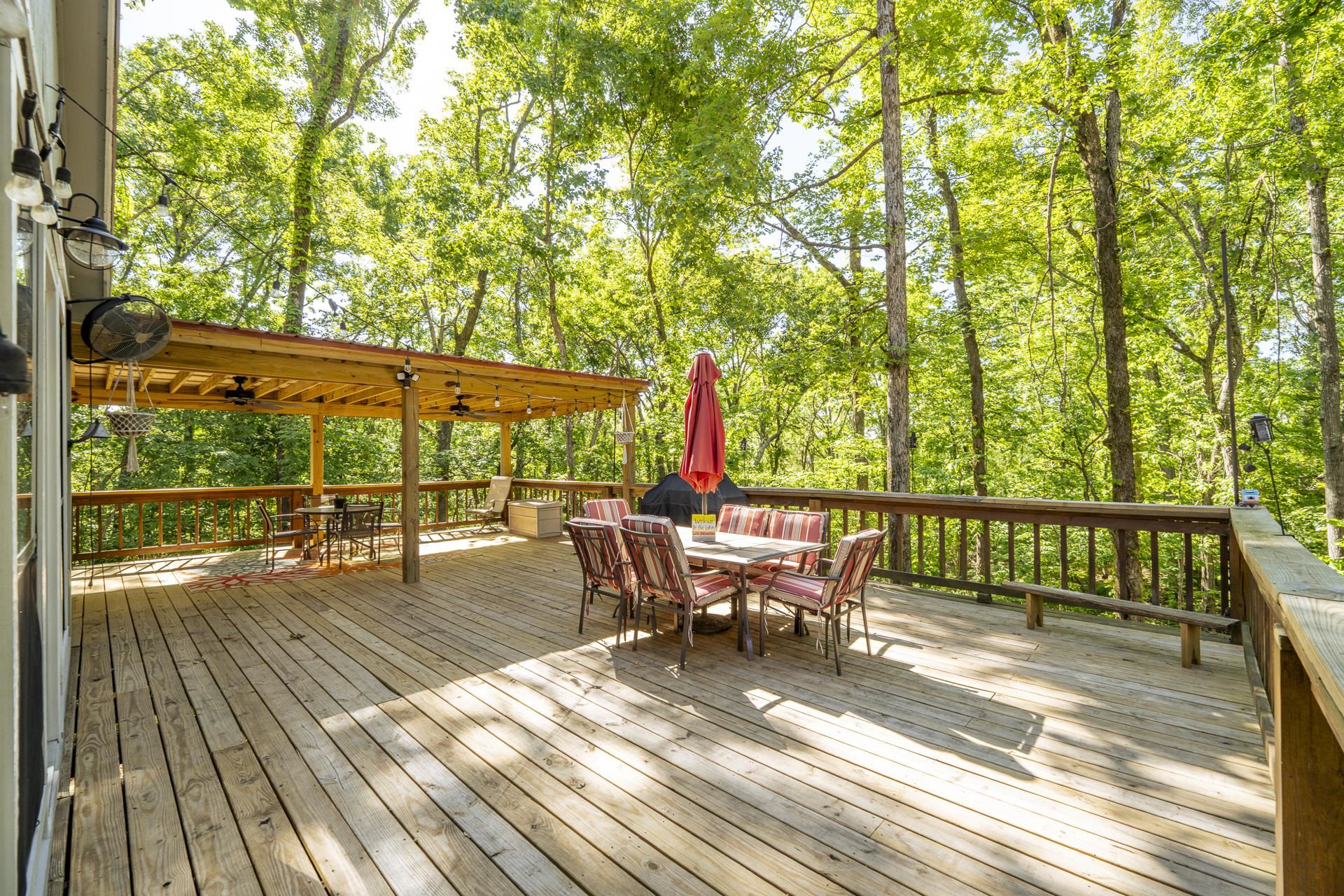 80 Contreau Road Counce, TN 38326 - Photo 20 of 28 a view of a patio with dining table and chairs with wooden floor