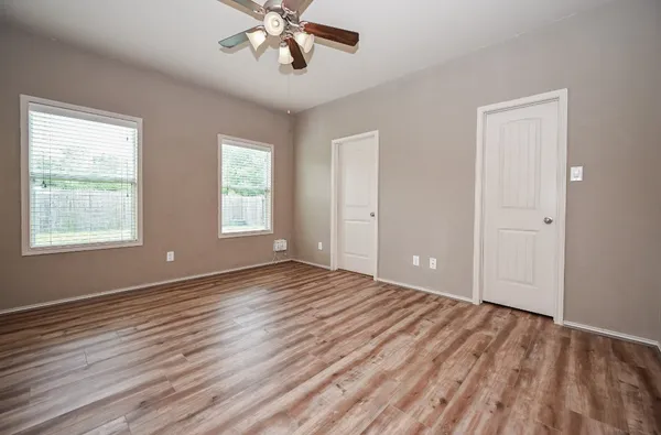 wooden floor in an empty room with a window