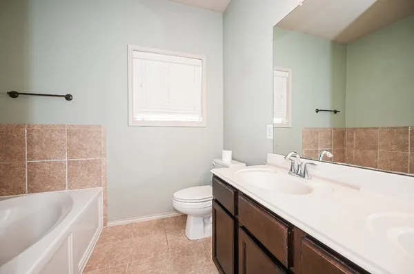 a bathroom with a sink vanity and a mirror