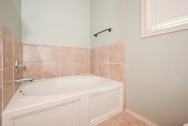 a bathroom with a bathtub and shower