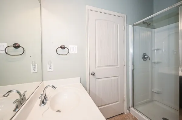 an empty room with a window and a ceiling fan