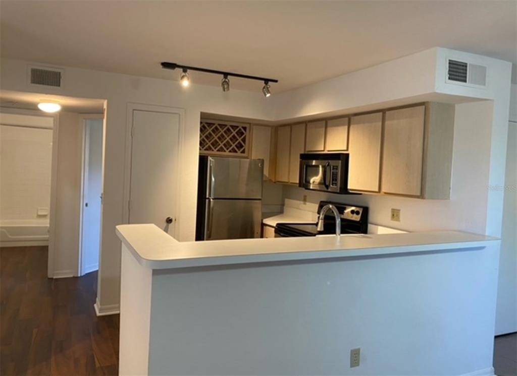 7300 Westpointe Boulevard, Unit 723 Orlando, FL 32835 - Photo 2 of 6 a kitchen with a sink and refrigerator