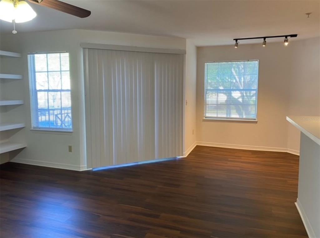 7300 Westpointe Boulevard, Unit 723 Orlando, FL 32835 - Photo 5 of 6 an empty room with wooden floor and windows