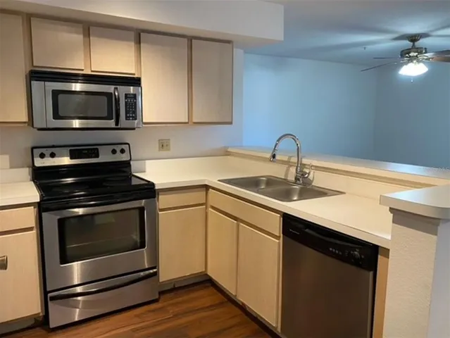 a kitchen with a sink stove and microwave