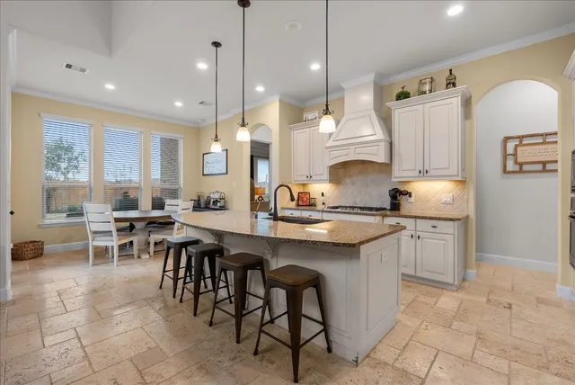 a view of a dining room with furniture and a window
